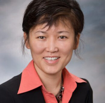photo of Dr. Ma in a salmon colored blouse and black suit coat 