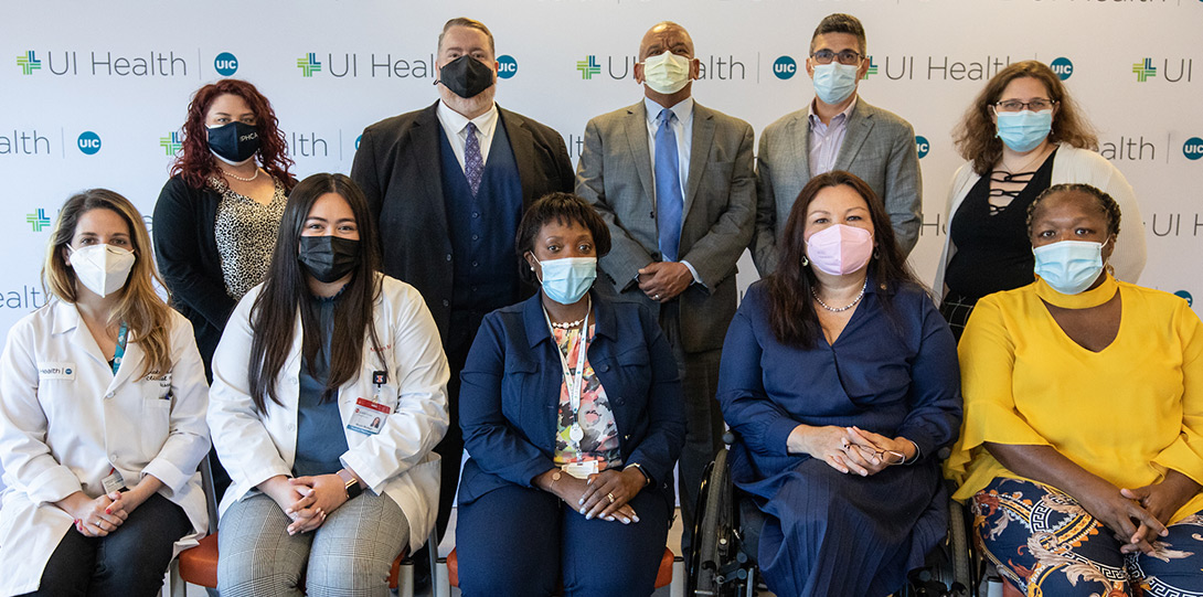 A group photo of the roundtable participants, all wearing masks