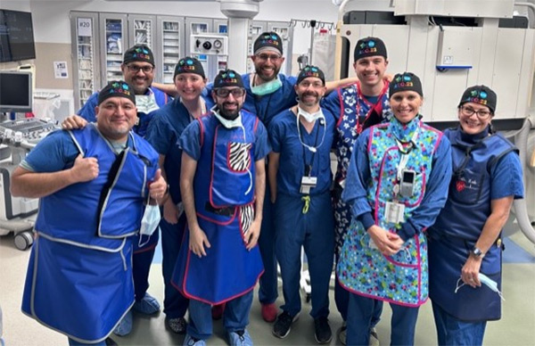 UI Health surgeons in scrubs posing together in an operating room
