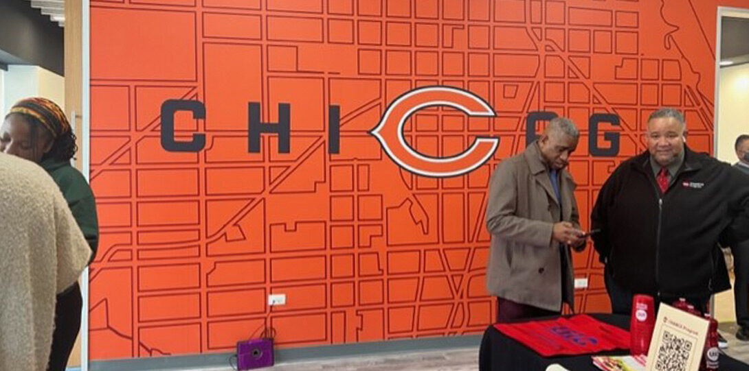 A wall in the facility with a large orange map of Chicago with the Chicago Bears logo