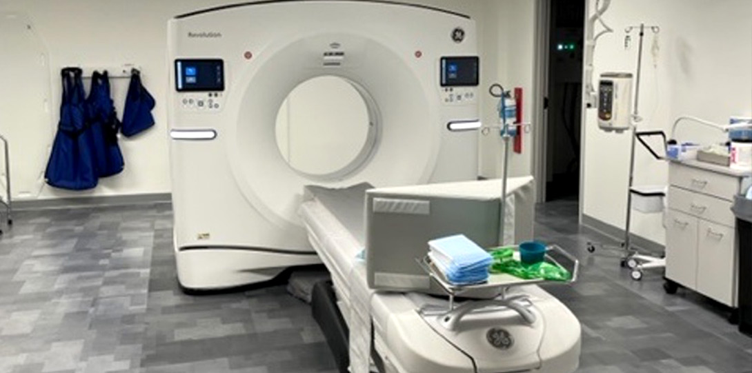 bright room with a modern CT scan machine in the middle of it