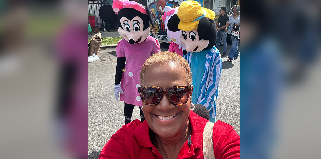 Dr. Hayes selfie in front the Mickey and Minnie Mouse characters