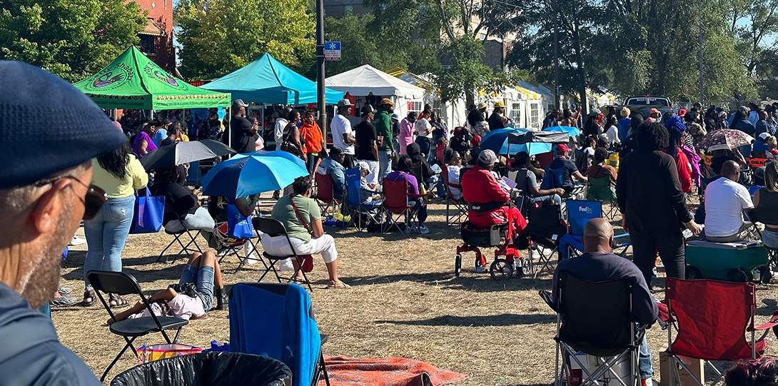 a view of a park with many tens of vendors and many community members