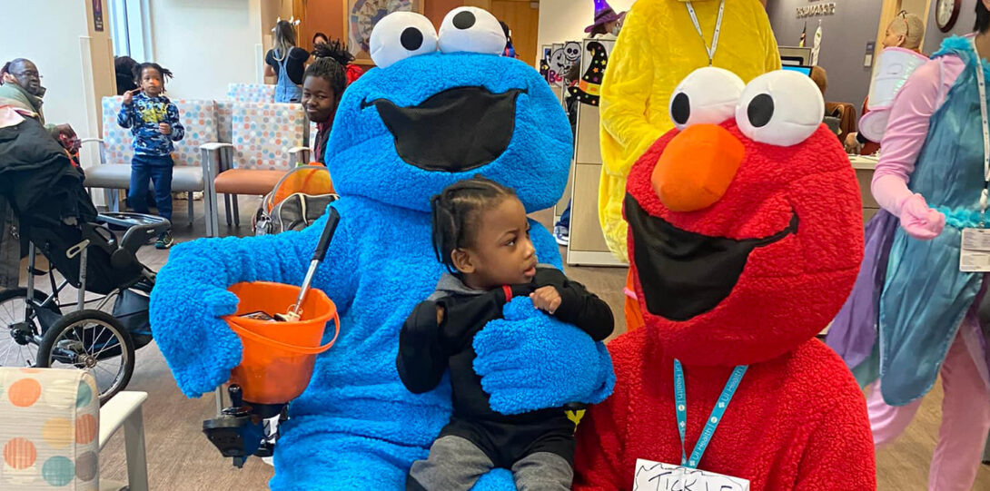 A young African American patient with Cookie Monster and Elmo