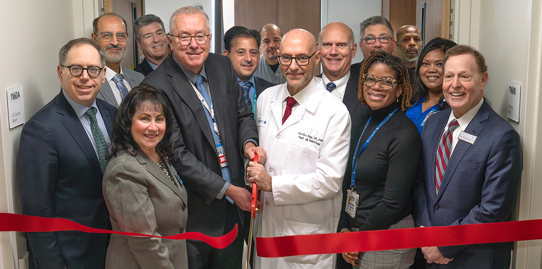 UI Health leadership in the new CT facility cutting a large red ribbon