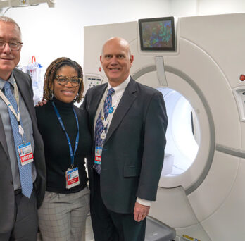UI health leaders posing next to the new CT scanner 