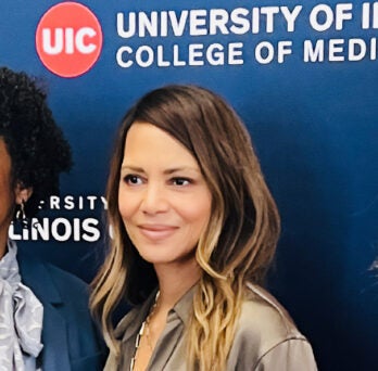Lt. Gov. Stratton, Halle Berry and Dr. Pauline Maki posing together in front of a UIC backdrop 